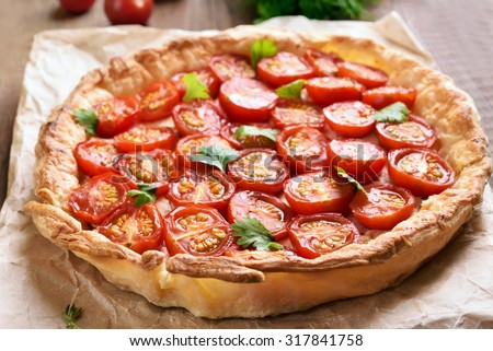 Tomato pie on baking paper, close up view