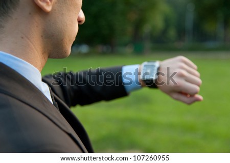 Man checking the time in the park