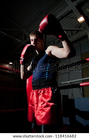 Young adult boxer fighting on the ring