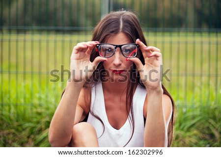Portrait Of Young Woman Wearing Hipster Glasses On Sports Playground