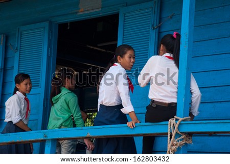 SIEM REAP, CAMBODIA - July 18, 2013: Asian boys and girls at local school on July 18, 2013, near Siem Reap, Cambodia