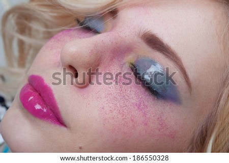 Modern futuristic Bright colorful creative make-up on woman face with powder on skin in studio