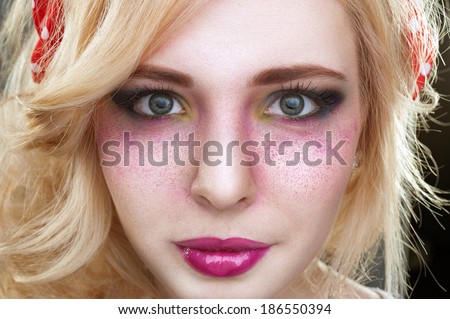 Pinup retro vintage Bright colorful creative make-up on woman face with powder on skin in studio