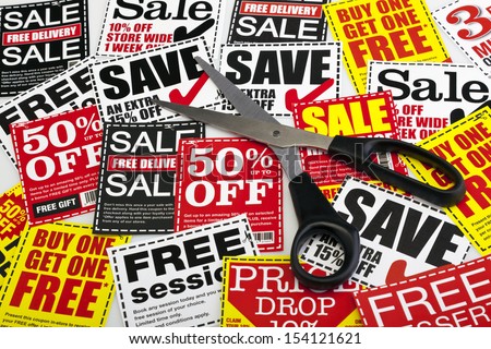 Money saving coupon vouchers with scissors. No dollar, euro or pound signs. Coupons created by photographer.