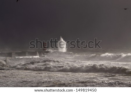 Storm at the entrance of the river Douro harbor. Low edition image; the light is coming from a momentary sunbeam.