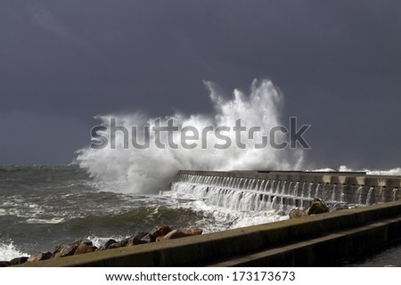 Big stormy waves over a pier and lighthouse, Porto, Portugal