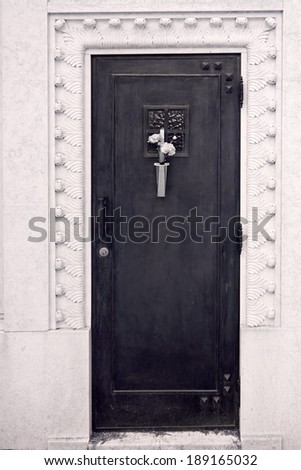 Cemetery chapel door with some flowers