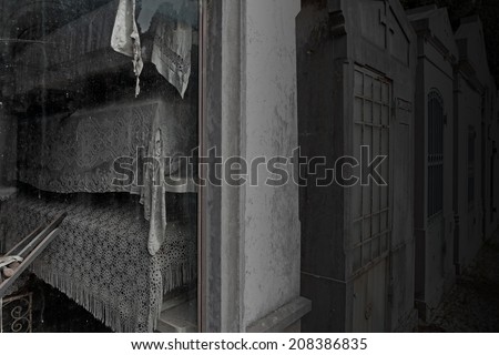 Spooky old european cemetery chapel with funeral urns covered with embroidered quilts