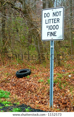 Do not litter sign with visible litter (tire) on ground.