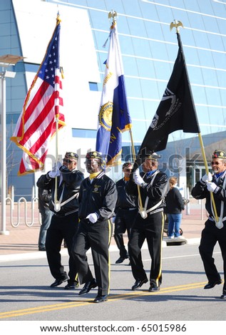 VIRGINIA BEACH,VA-NOV. 11:  Veterans marching with flags in the Veterans Day Parade on November 11, 2010 in Virginia Beach,VA