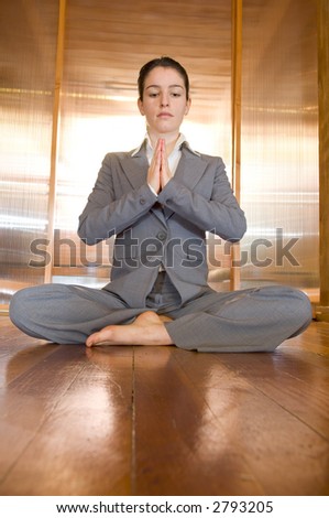 Dramatic angel of businesswoman in prayer pose