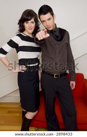 Couple standing with guy pointing.