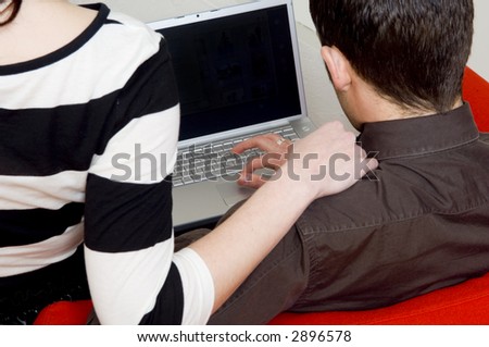 Couple looking at computer.