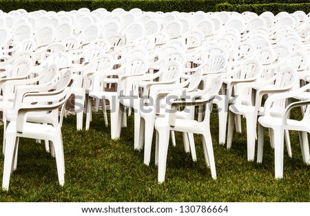 White chairs set up for open air concert