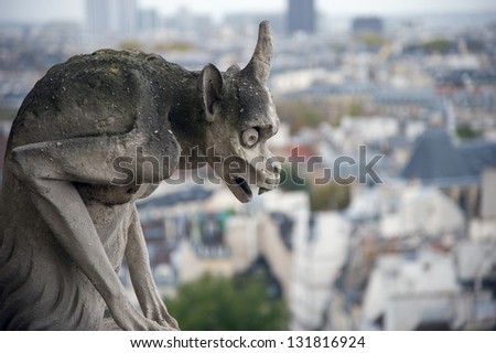 Stone gargoyle (Chimera) overlooking the city of Paris from the tower of the Notre Dame
