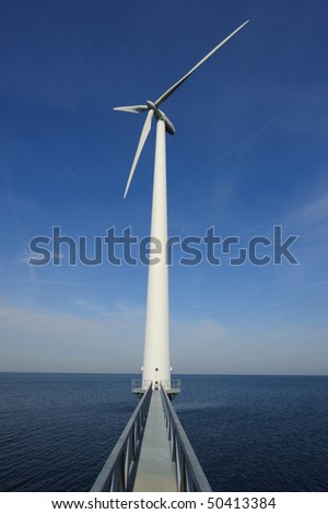 Bridge to wind turbine standing in the sea