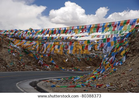 Colorful Tibetan prayer flags hanging across the road