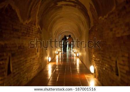 The tunnel with lights and two children at the end of tunnel