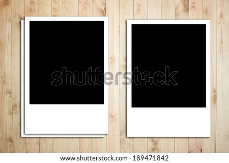 Polaroid photo frame on wood plank background, long shape of photo frame