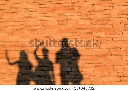 Shadow of a family on a house wall