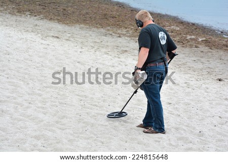 HEILIGENDAMM, GERMANY - August 22, 2014: a treasure hunter looking for metal objects on the Baltic Sea beach in Heiligendamm