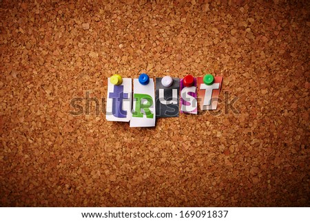 Trust - Cut out letters pinned on a notice board.