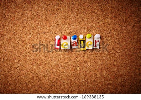 Leader   - Cut out letters pinned on a cork notice board.