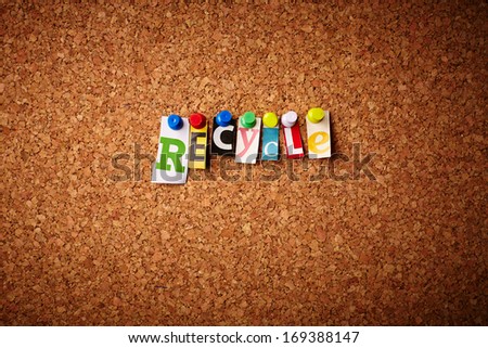 Recycle   - Cut out letters pinned on a cork notice board.