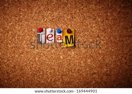 Team - Cut out letters pinned on a cork notice board.