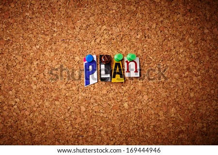 Plan - Cut out letters pinned on a cork notice board.