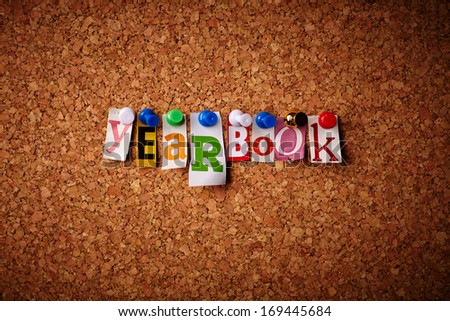 Yearbook - Cut out letters pinned on a cork notice board.