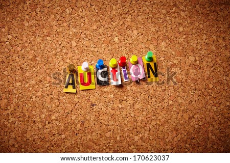 Auction - Cut out letters pinned on a notice board.