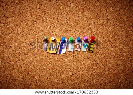 Improve  - Cut out letters pinned on a notice board.
