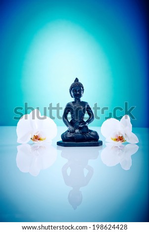 Buddah with white orchis Wellness and Spa Image, works perfect for advertising Health and Beauty, Spirituality or Massage.