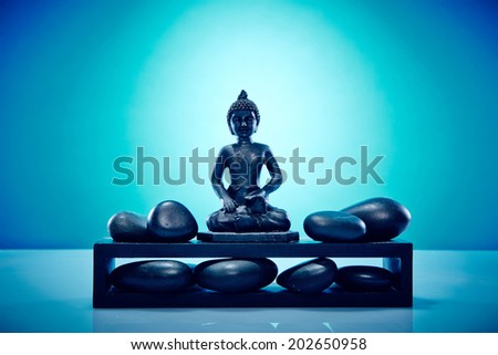 Buddah with hot stones. Image of a buddah with hot stones, works perfect for spirituality, relaxation or massage.