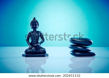 Buddah with a staple of hot stones. Image of a buddah with hot stones, works perfect for spirituality, relaxation or massage.