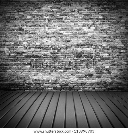 dark brick wall texture in basement house interior with beam of light and wooden floor, may use as grunge halloween background or night club advertising