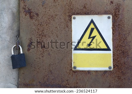old rusty metal door and padlock and warning attention sign board and empty space to your own text