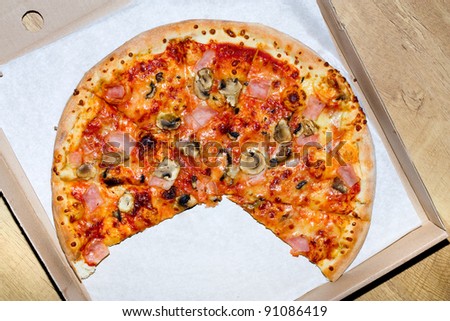 hot italian pizza in cardboard box on white paper background