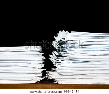 stack of documents or files, heap, overload of paperwork on black background