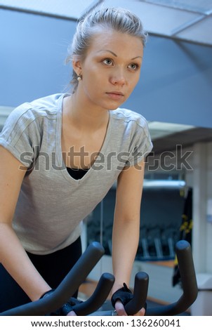 Woman biking in gym