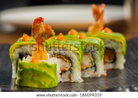 sushi roll with  shrimp tempura at restaurant