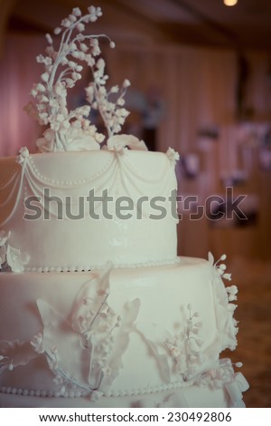 Beautiful white wedding cake, decorated with lilies of the Valley