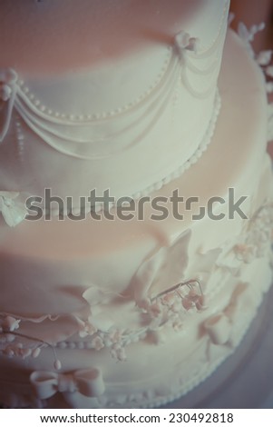 Beautiful white wedding cake, decorated with lilies of the Valley