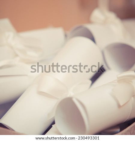 Creative invitations are roll up in the scrolls. Background