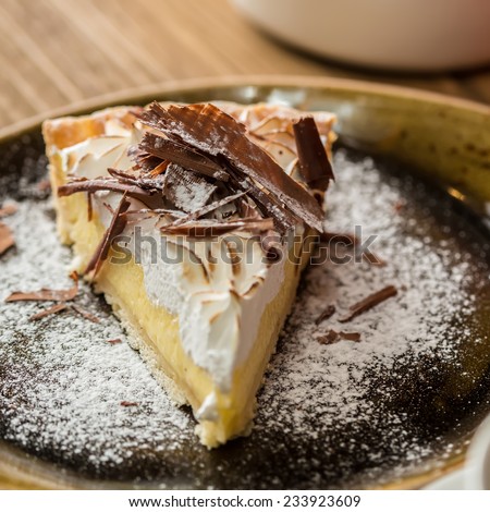 Cheesecake with Chocolate, baked to perfection. On plate with terracotta background.