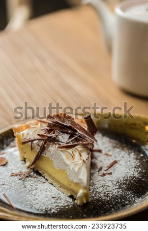 Cheesecake with Chocolate, baked to perfection. On plate with terracotta background.