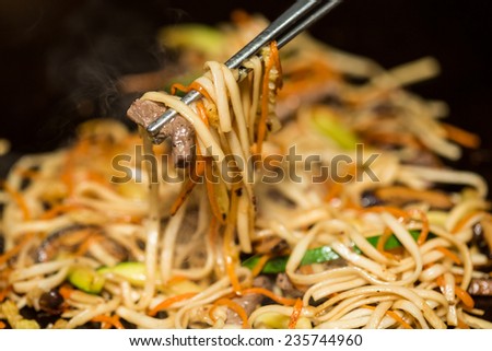 Preparing pad thai at a street hawker mobile restaurant in Bangkok, Thailand. Fried noodle. Shallow dof.