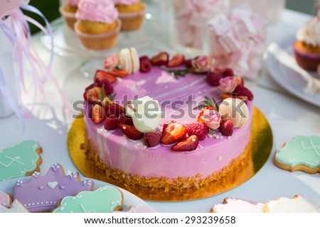 Dessert table for a party. Cake, cupcakes, sweetness and flowers. Shallow dof