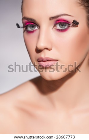 eye makeup with feathers. eye with feathers on